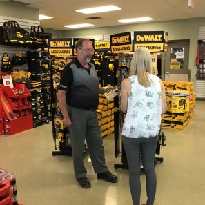 A male sales representative assisting a female customer shopping at William Knell & Company Limited (Knell's) Industrial Supply Showroom.